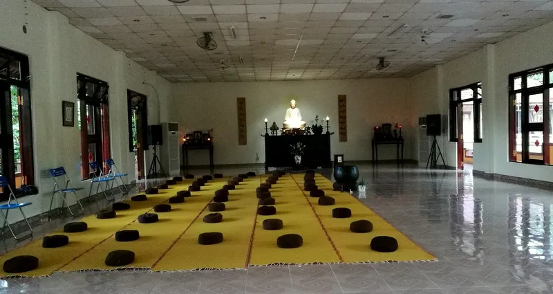 An empty meditation hall lined with cushions